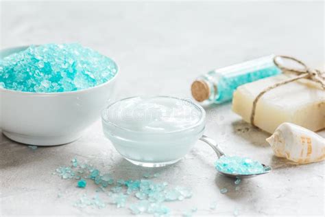 Blue Bath Salt Body Cream And Shells For Spa On White Table Background