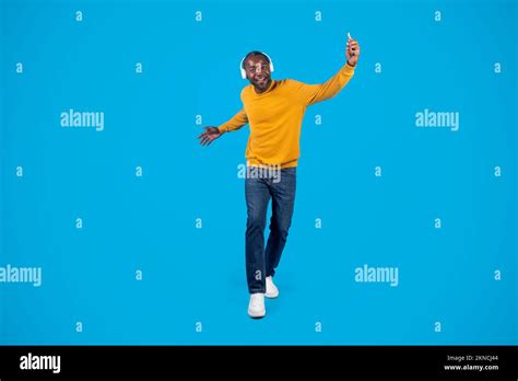 Positive Energetic Black Man With Headphones Listening To Music Stock