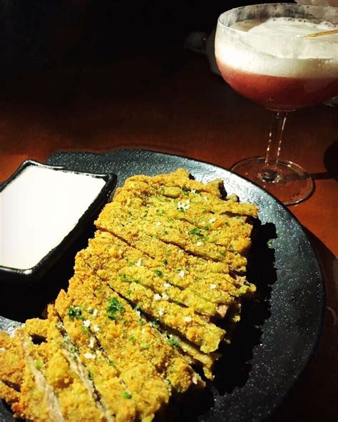 A Plate With Some Food On It Next To A Drink