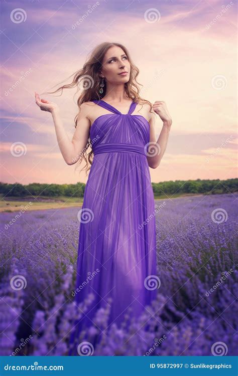 Young Woman With Long Blonde Hair In A Purple Dress Looking At T Stock