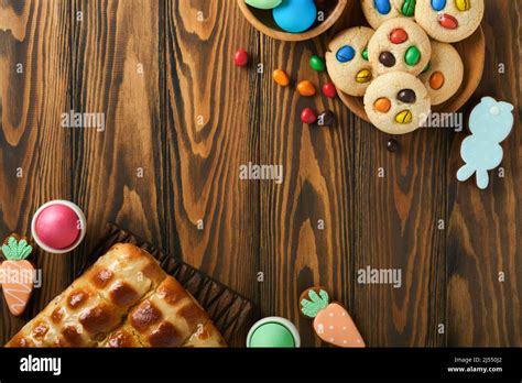 Easter Hot Cross Buns With Colored Eggs Easter Gingerbread Rabbits And Cookies Over Dark Brown