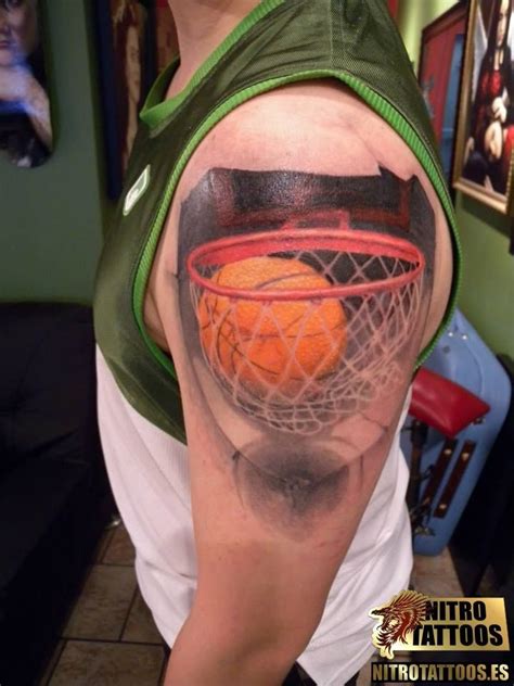 A Man With A Basketball And Net Tattoo On His Left Upper Arm Holding