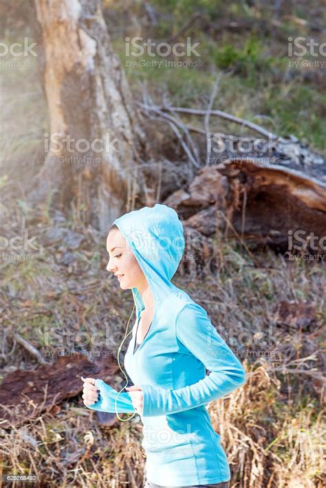 Female Runner During Outdoor Workout In Nature Stock Photo Download