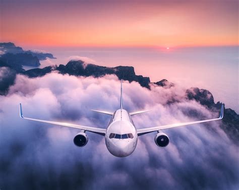 Airplane Is Flying Over Clouds At Sunset In Summer Landscape With