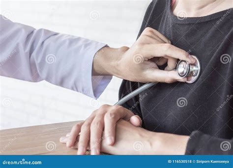 Doctor with Stethoscope in Hand Examining Female Patient Heart Beat Stock Photo - Image of ...