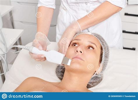 Beautician Makes Facial Ultrasonic Peeling For Rejuvenation Woman Face