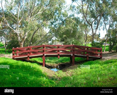 Wooden bridge across creek Stock Photo - Alamy