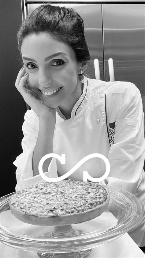 A Woman Sitting In Front Of A Cake