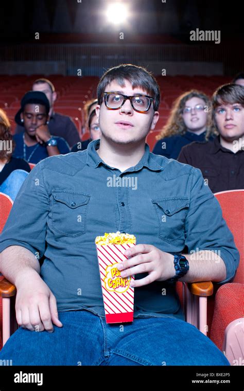 Caucasian Man Eating Popcorn In Movie Theater Stock Photo Alamy