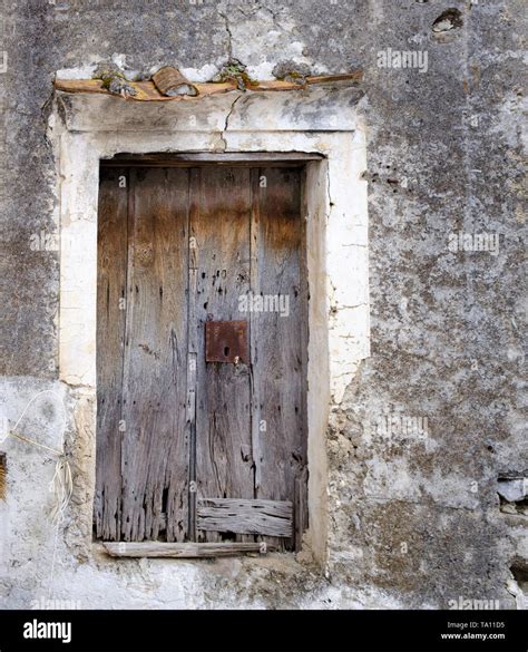 Ancient worn out dilapidated weathered faded wooden door with rusty ...