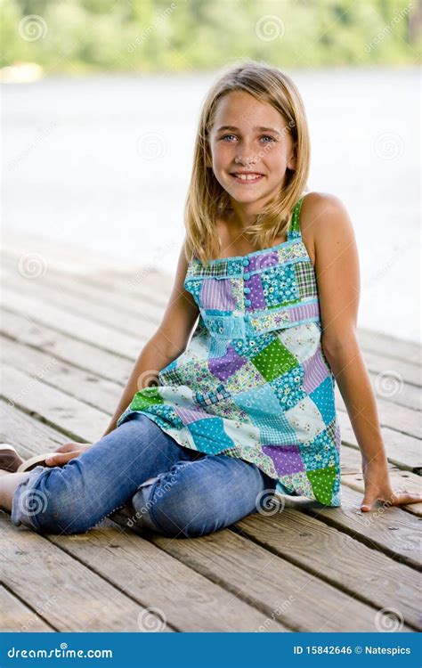 Young Tween Girl Sitting On A Pier Royalty Free Stock Image Image