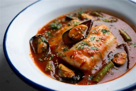 Premium Photo Hake With Tomato Sauce And Mussels Traditional Recipe