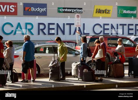 People, passengers waiting for ground transportation outside the rental ...