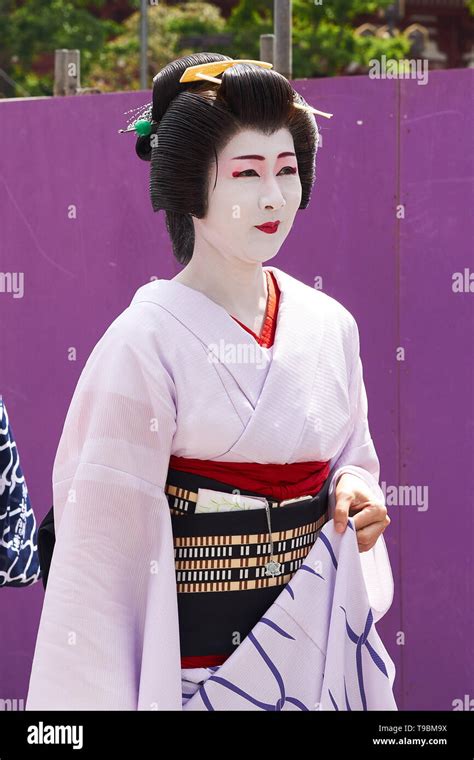 Woman Dressed As Geisha In Traditional Japanese Clothing Kimono