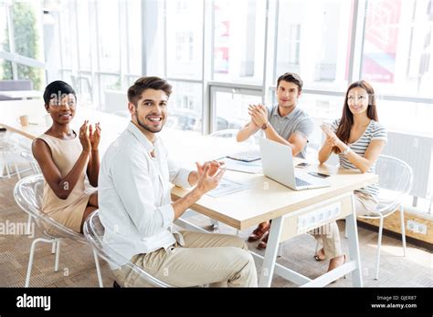 Multiethnic Group Of Happy Young Business People Clapping Hands On