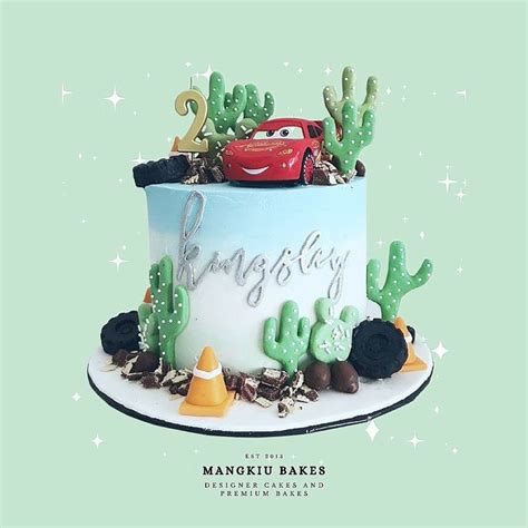 a birthday cake with cars and cactus on top