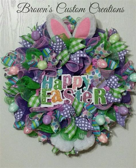 A Wreath With The Words Happy Easter Written On It And Some Bunny Ears