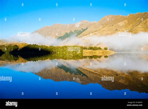 Misty Dawn Reflections On Calm Lake Moke Queenstown Otago South