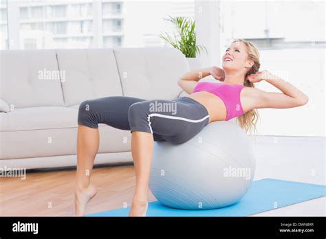 Smiling Blonde Doing Sit Ups With Exercise Ball Stock Photo Alamy