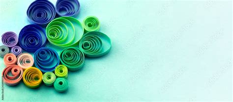 Paper quilling, or quilled paper. Spectrum of coiled paper strips in many colors. Background or ...