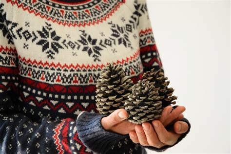 Premium Photo Midsection Of Woman Holding Pine Cones