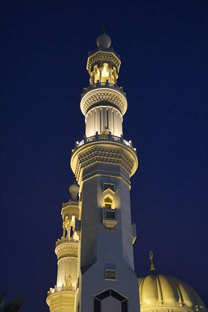 Premium Photo | Low angle shot of illuminated madina minar in uae at night