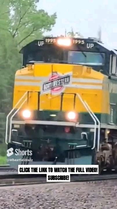 UP 1995 THE CNW HERITAGE UNIT LEADS A WB STACK TRAIN IN MARYSVILLE KS