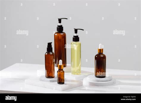 Spa Cosmetics In Brown Glass Bottles On Gray Concrete Table Copy Space For Text Beauty Blogger