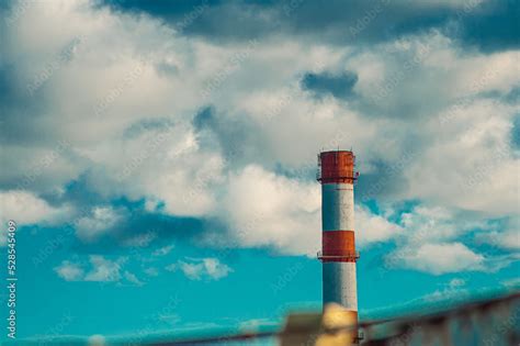 Top Of Industrial Smoke Pipe Against The Blue Sky Background Factory