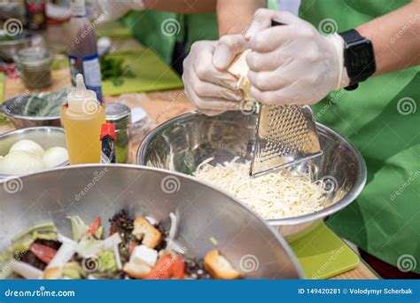 Woman Grating Cheese On Kitchen Table Cooking Process Stock Image