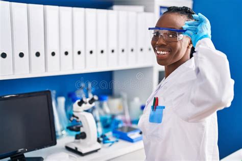 African American Woman Scientist Smiling Confident At Laboratory Stock