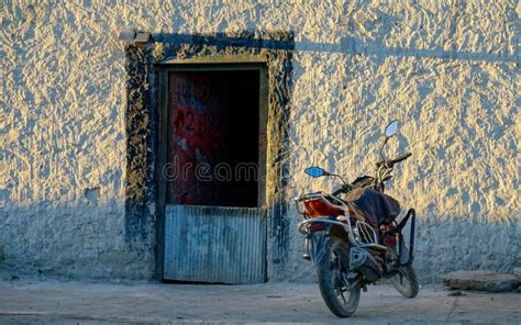 CLOSE UP Red Motorcycle Is Parked In Front Of A Traditional Tibetan