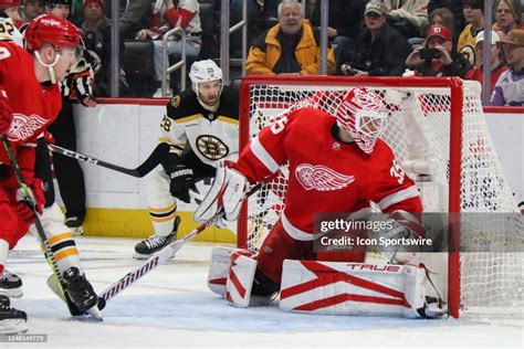 Detroit Red Wings goalie Ville Husso looks for the puck as he guards ...