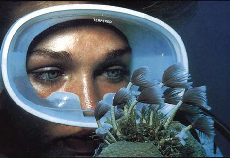 A Woman Wearing A Diving Mask With Seaweed In Front Of Her Face And The