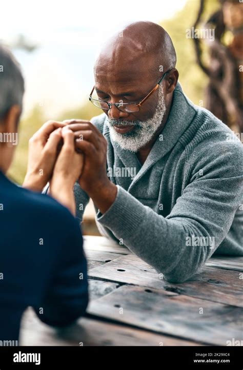 Couples Who Pray Together Stay Together Cropped Shot Of A Senior Couple Praying Outdoors Stock