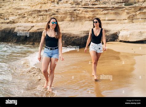 Two Beautiful Young Girls Walking On The Beach Stock Photo Alamy