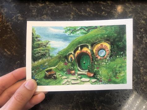 A hobbit sized watercolor painting of a hobbit hole : lotr