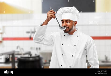 happy indian chef tasting food by ladle at kitchen Stock Photo - Alamy