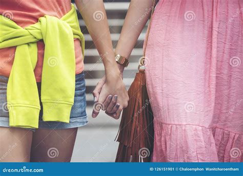 Two Women Friends Walking And Holding Hands Happily Stock Image