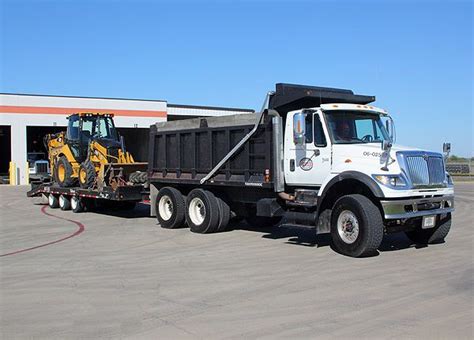 Dump Truck With The Backhoe On A Trailer For The Backhoe Ready To Be