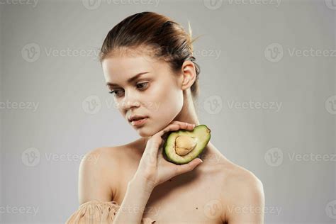 Beautiful Brunette Naked Shoulders Avocado In Clean Skin Hand