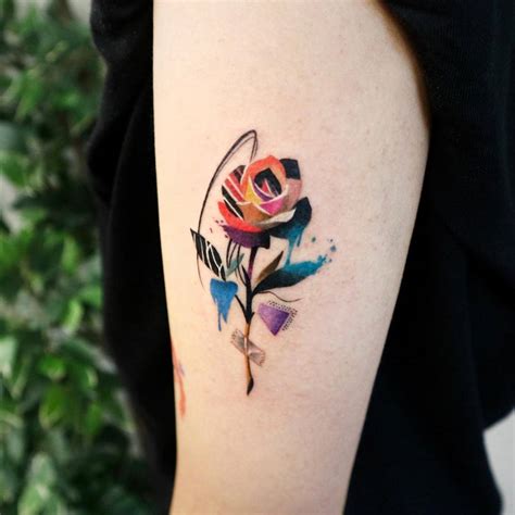 Paper Collage Rose Tattoo Located On The Upper Arm