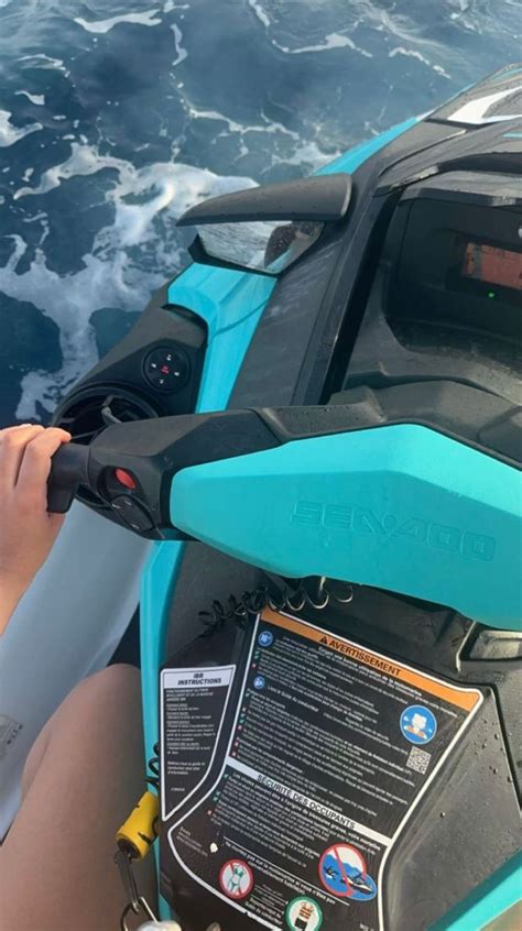 A Person Riding On The Back Of A Blue And Black Jet Ski