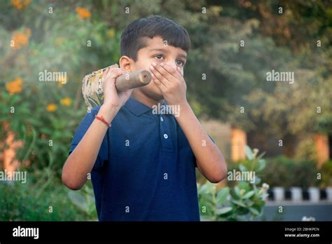 Boy Coughing And Covering Mouth With Hand While Playing Stock Photo Alamy