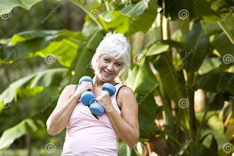 Mature Woman Exercising In Park With Hand Weights Stock Image Image