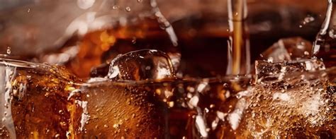 Premium Photo Pouring Of Cola And Ice Cola Soda And Ice Splashing