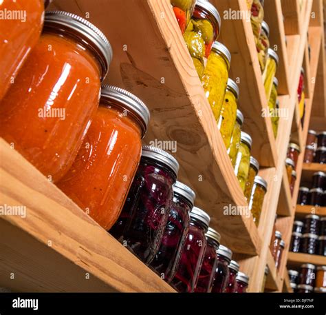 Canned Goods On Wooden Storage Shelves In Pantry Stock Photo Alamy