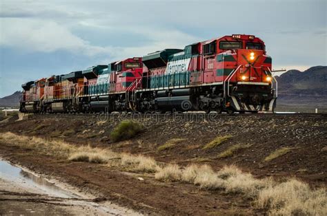 Red and Green Train Moving through the Mountains on a Rainy Day Editorial Photo - Image of ...