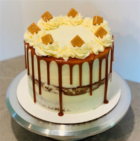 Banana Caramel Cake Semi Naked Cake With Caramel Drip And Caramel Squares And Frosting Swirls