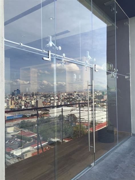 A Window With Glass On The Outside And City In The Background